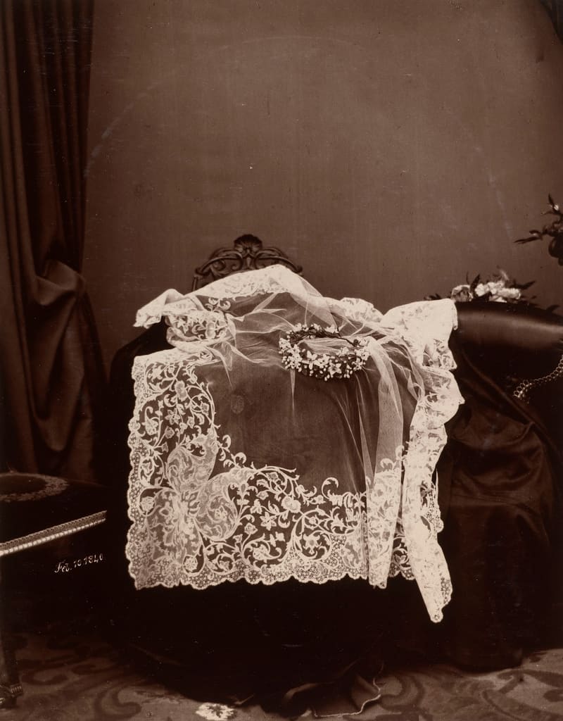 Photograph of Queen Victoria's Honiton lace wedding veil laid out with a wreath of orange blossom